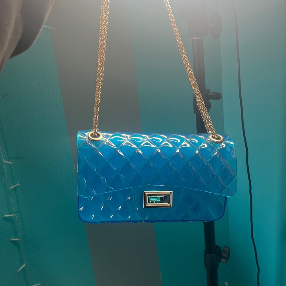 A gel blue purse what gold handles.